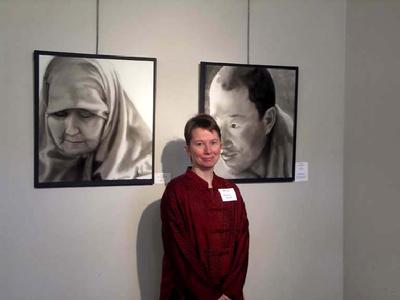 Installation photograph of Barbara Stout with two of her portraits, Seattle, WA